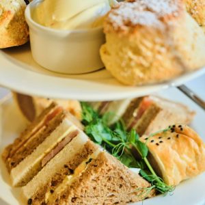 Close up of a selection of sandwiches and scones for afternoon tea