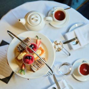 Aerial view of afternoon tea cake stand and cups of teas