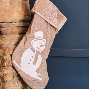 Stocking with a snowman hanging from the fireplace