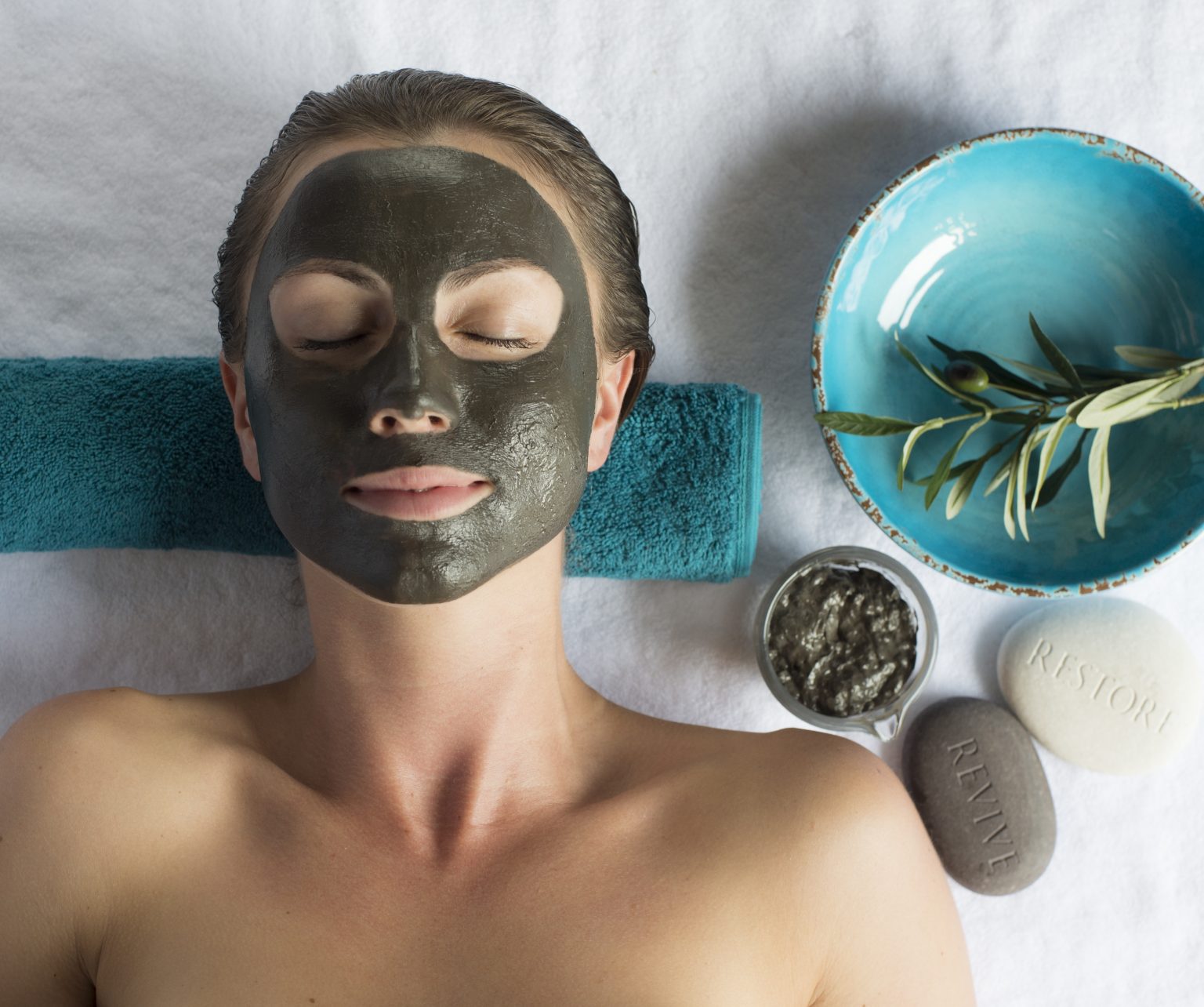 Woman with a dark coloured facial mask
