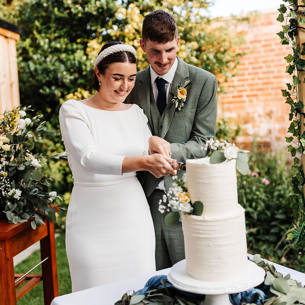 bride and groom cutting the cake at their reception