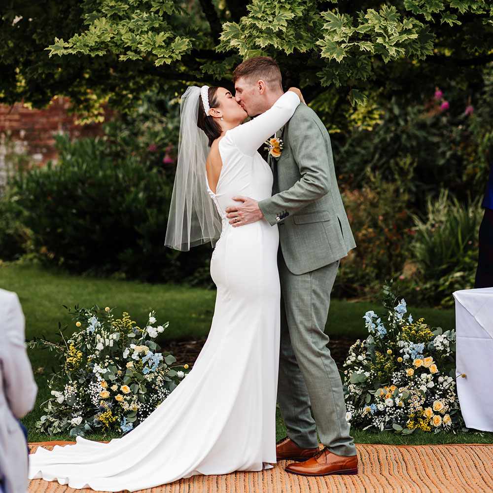 Issie and Chris first kiss in garden ceremony