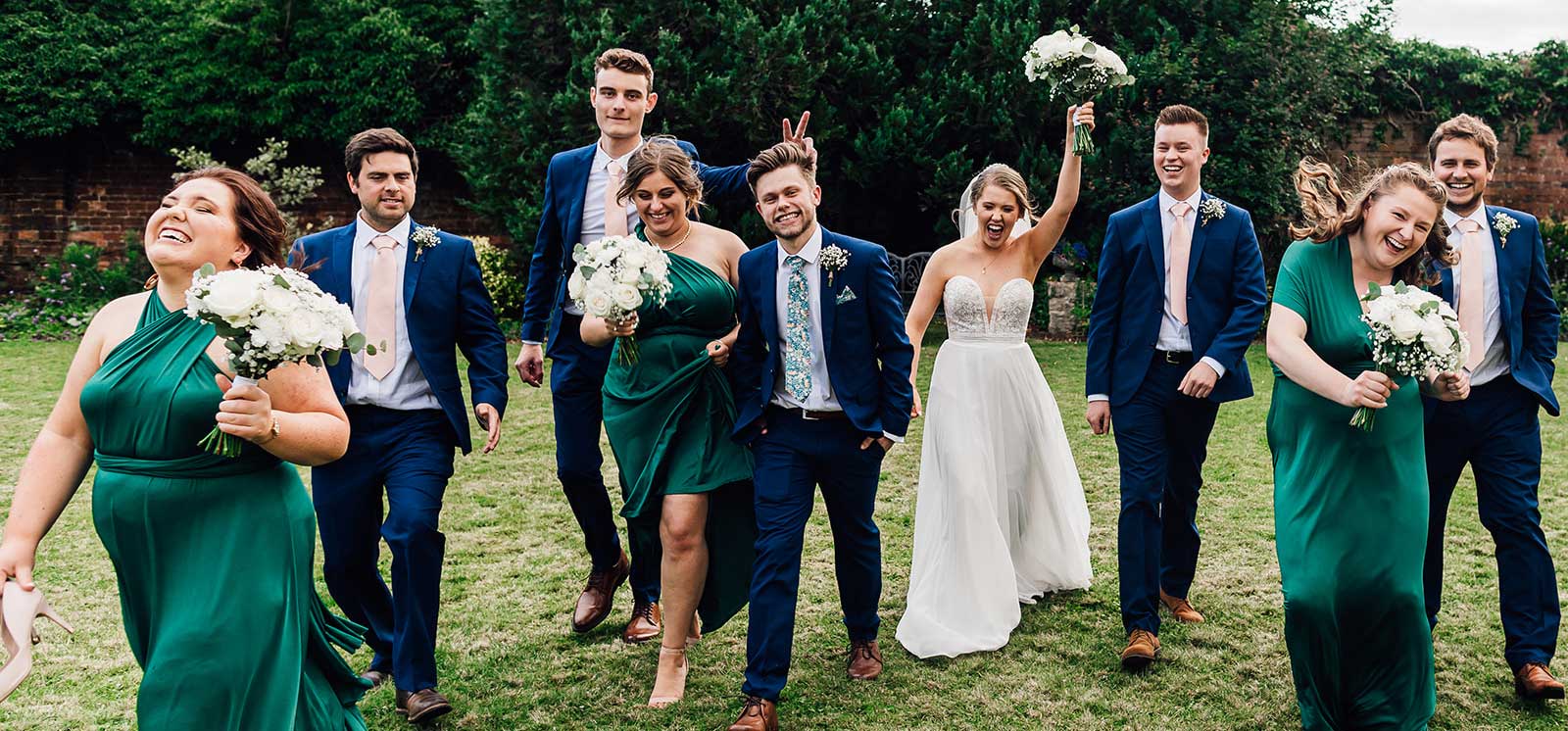 Wedding party strolling across the garden