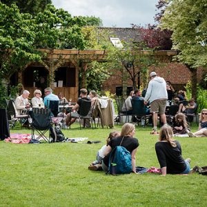 people enjoying the sunshine in the garden at the May bank holiday party