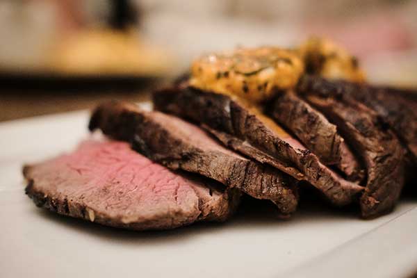 Close up of a sliced Chateaubriand with sauce