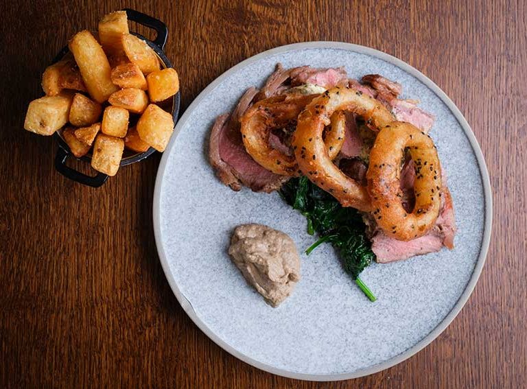 Sirloin beef with chunky chips, onion rings and mushroom puree in the garden restaurant