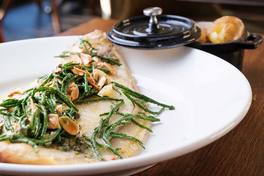 Whole roast sole with lemons and toasted almonds in the garden restaurant