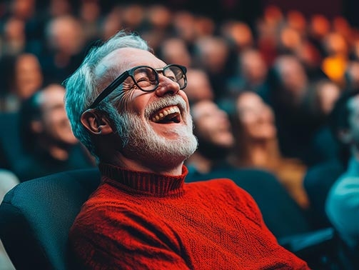 Theatre Audience with man smiling and enjoying a performance