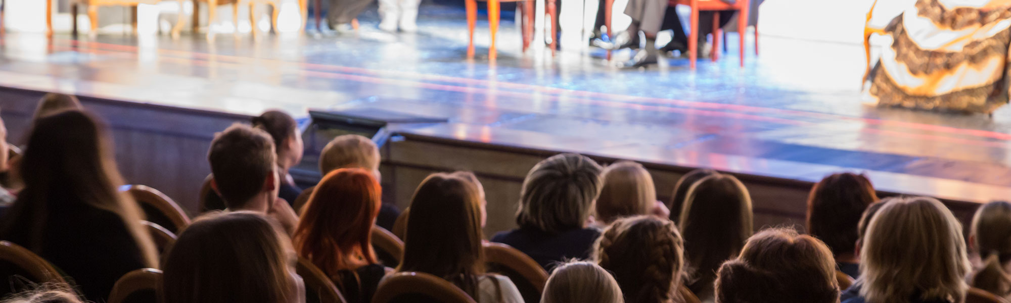 Theatre audience watching a play on stage