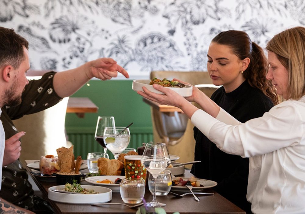 Group of 4 people eating a meal in the garden restaurant