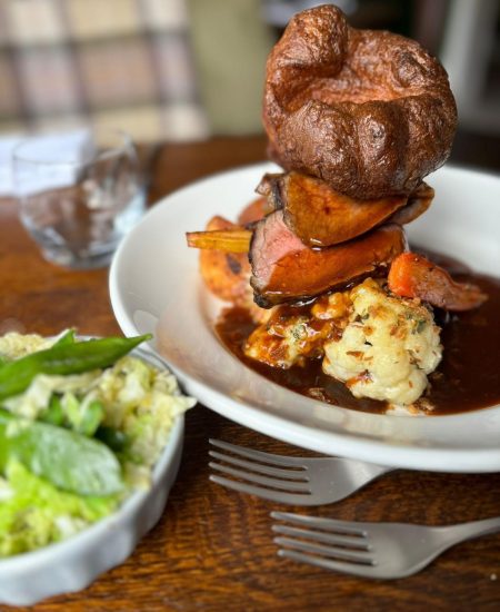 Plate of roast beef Sunday lunch with seasonal veg, Yorkshire pudding and gravy