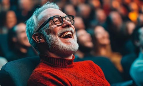 Theatre Audience with man smiling and enjoying a performance