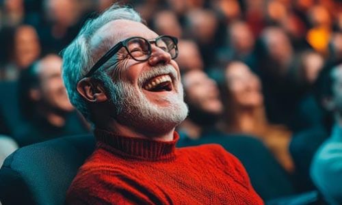 Theatre Audience with man smiling and enjoying a performance