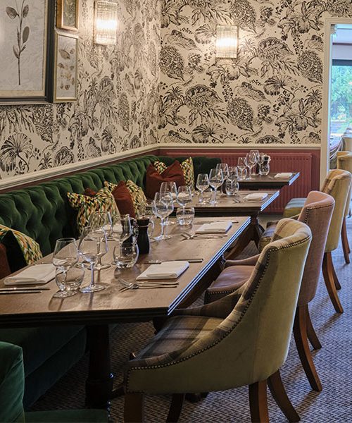 table with a bench and chairs in the garden restaurant